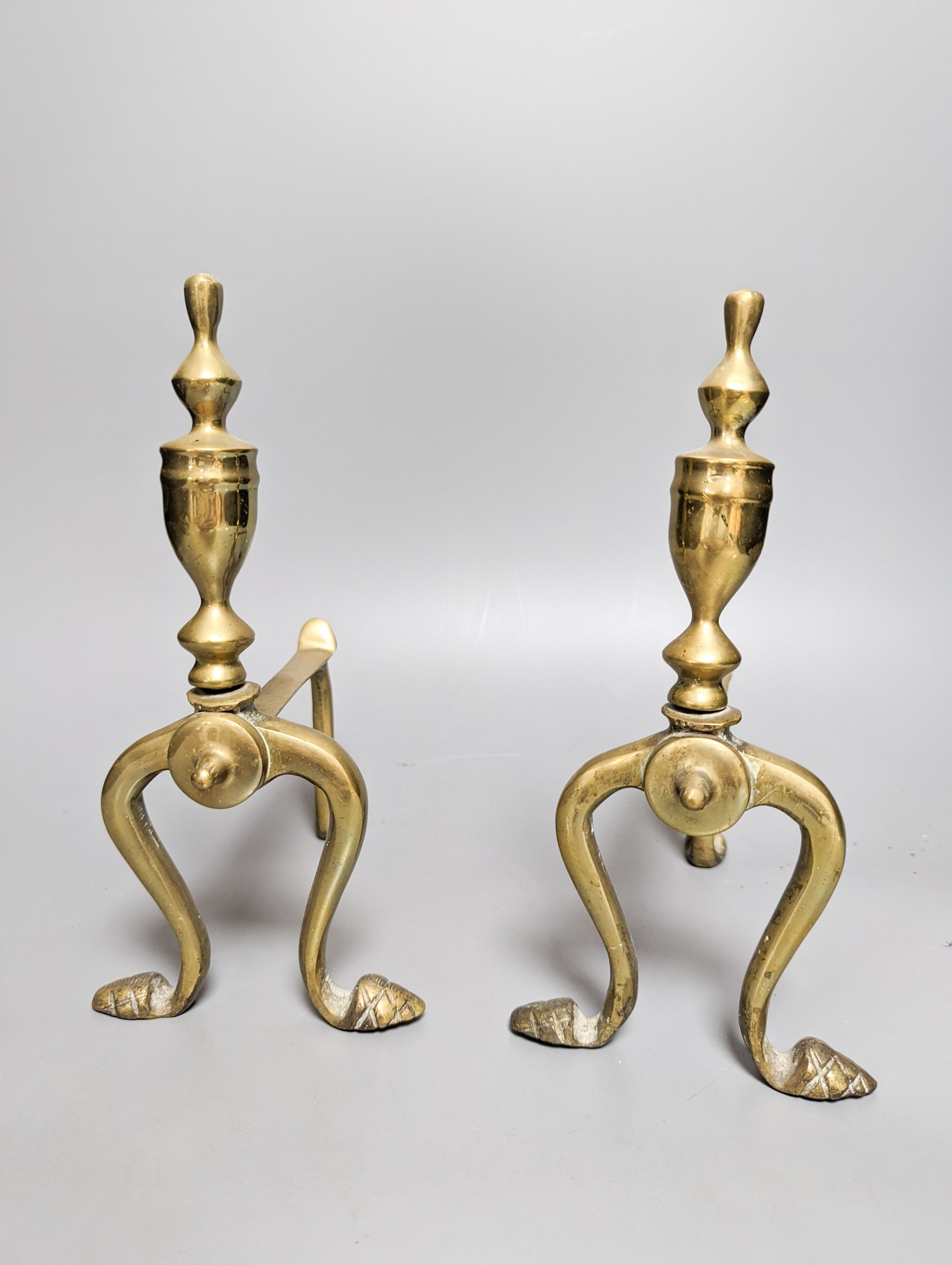 A pair of Empire style ormolu candlesticks and a pair of fire irons tallest 36cm